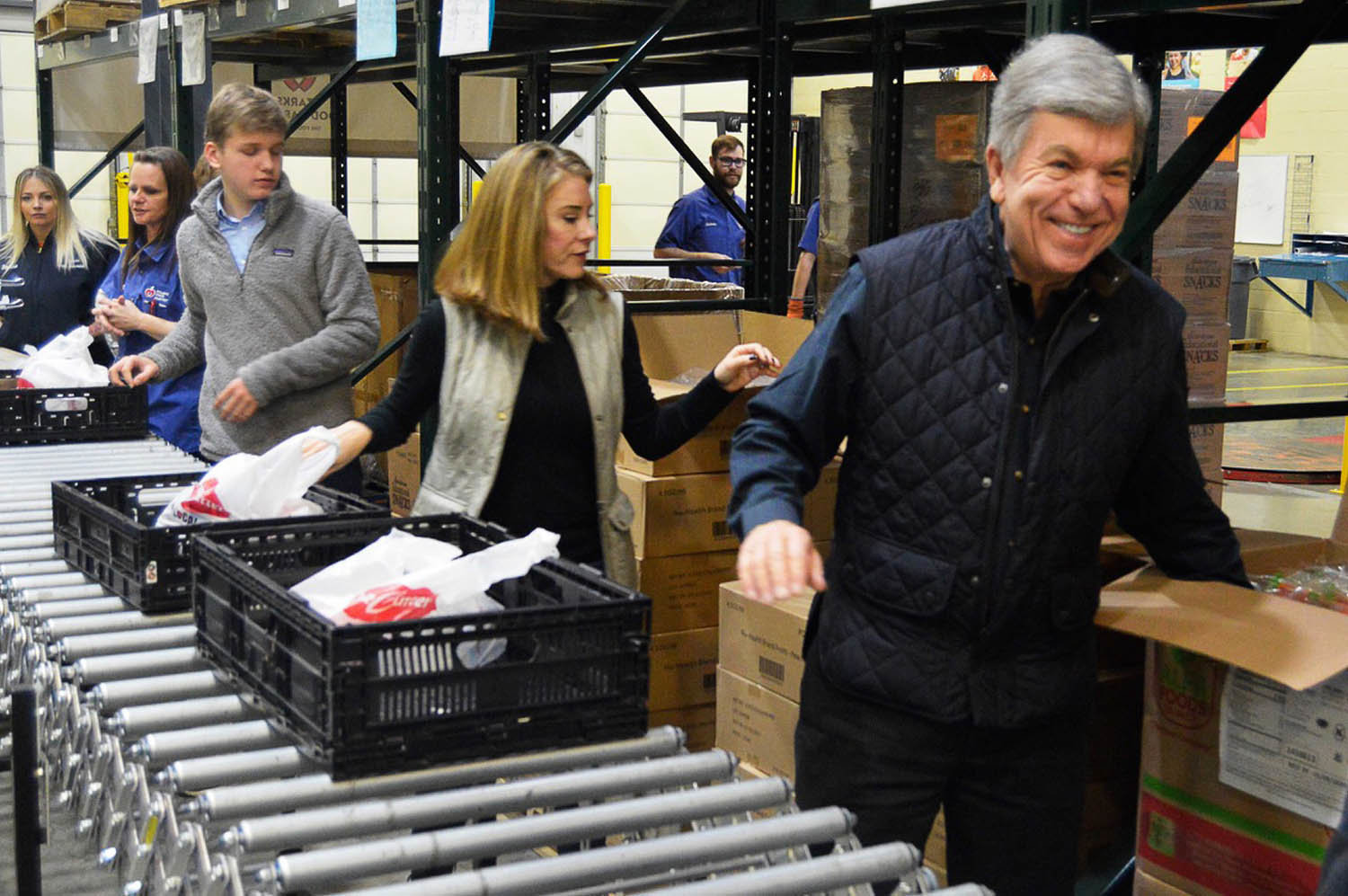 VOLUNTEER SENATOR
U.S. Sen. Roy Blunt, at right, packs bags of food Dec. 30 at Ozarks Food Harvest. He visited the food bank to thank volunteers for their service during the holidays and to bring attention to the issue of food insecurity in southwest Missouri. Officials say January and February are peak demand months.